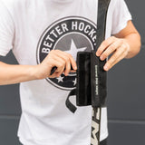 Person applying Extreme Hockey Pro Stick Weight to improve shooting and stickhandling skills with a hockey stick.